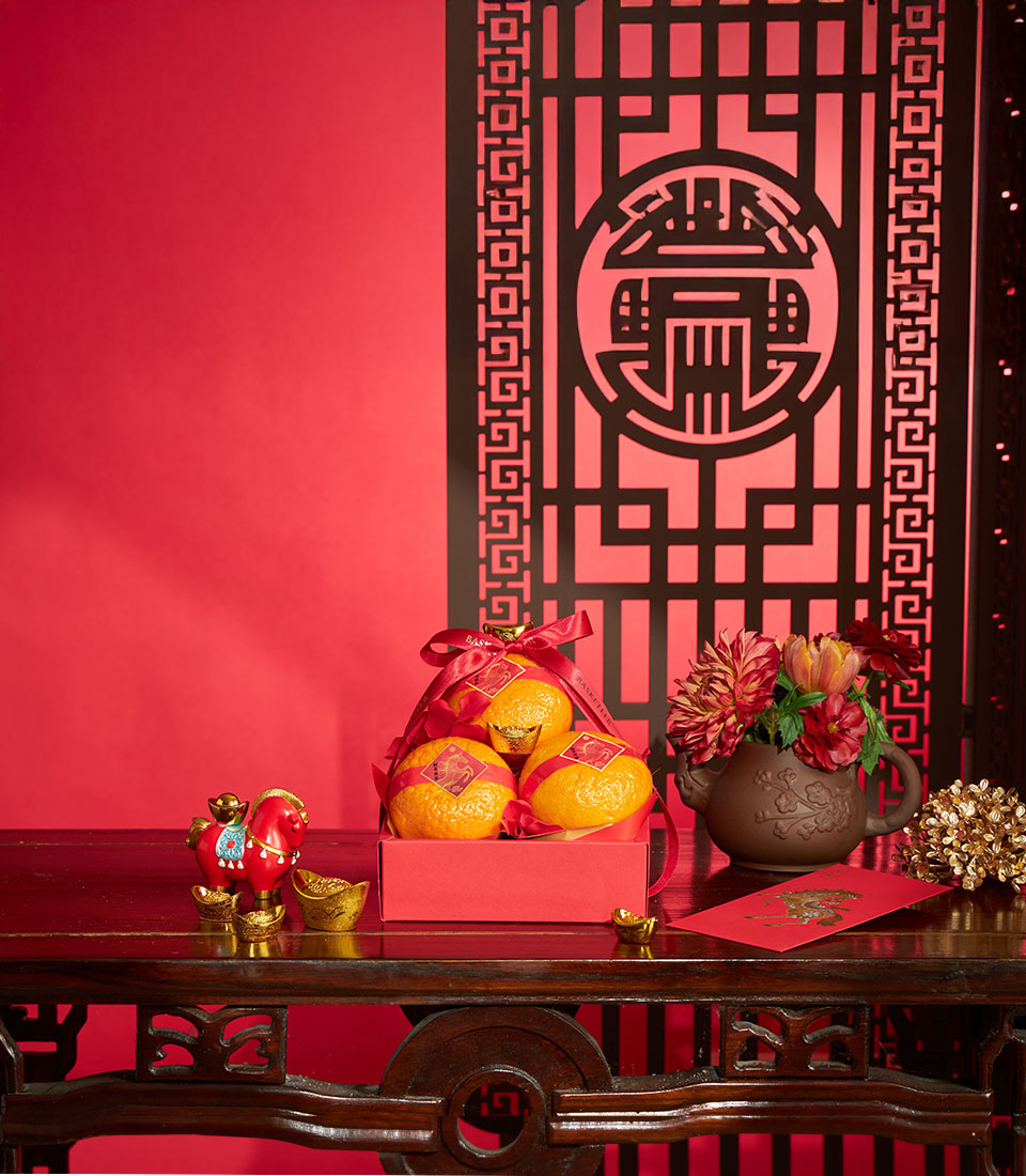 Premium mandarin orange gift box with gold accents and red ribbon for Chinese New Year celebrations