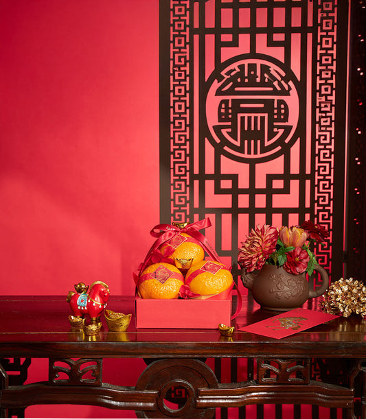 Premium mandarin orange gift box with gold accents and red ribbon for Chinese New Year celebrations