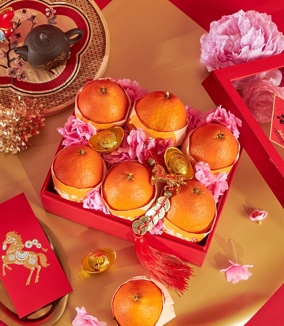 Prosperity Mandarin Orange Gift Box with ceramic teapot, golden ingots, and pink flowers for Chinese New Year