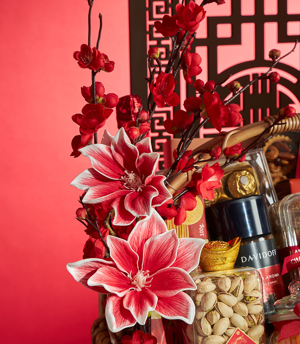 Prosperity Gourmet Chinese New Year gift basket with red magnolia flowers, pistachios, Davidoff coffee, gold ingot, and