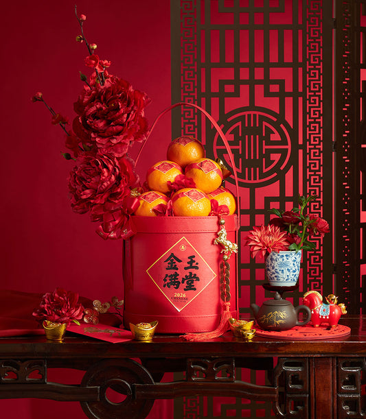 Red leather mandarin orange basket with gold coin tassel and red peonies for Chinese New Year gifts