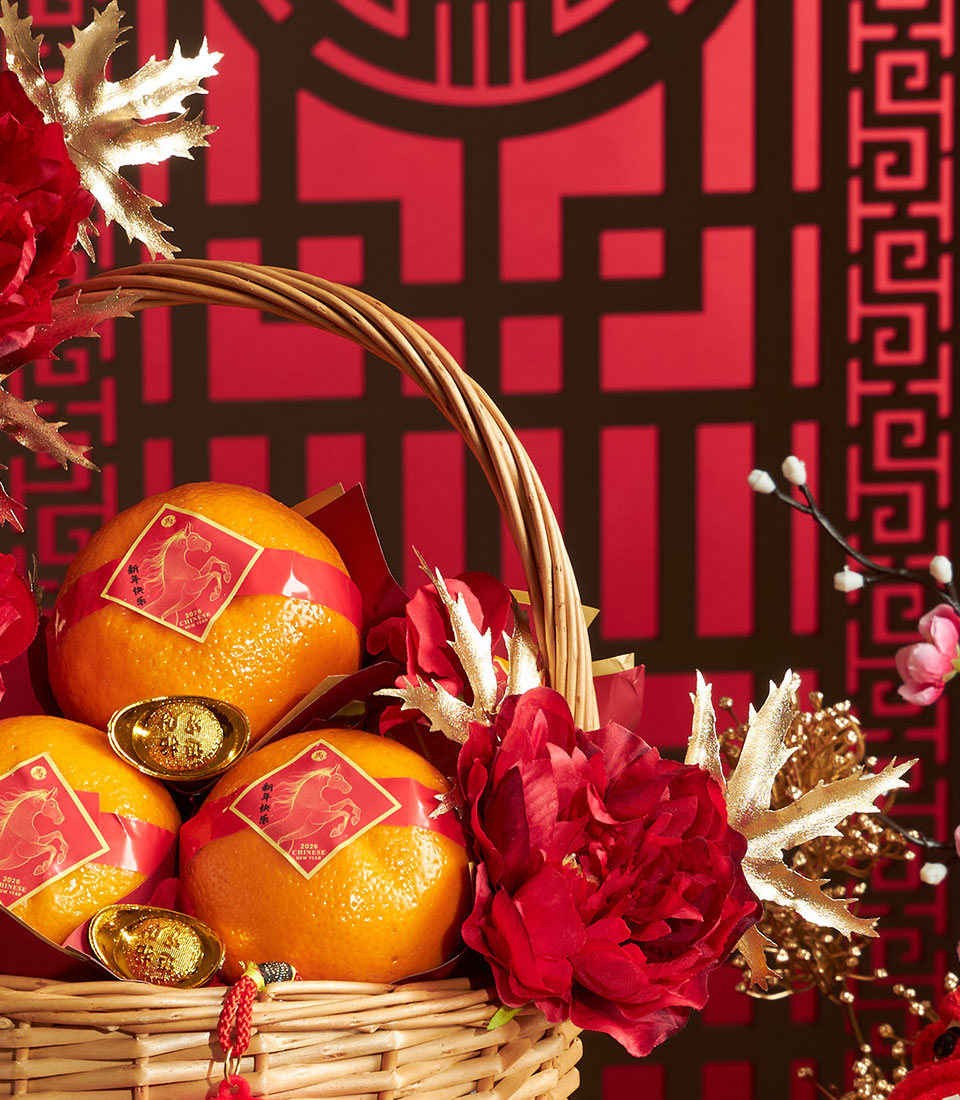 Luxury Mandarin orange gift basket with red ribbons, gold ingots, and festive peonies for Chinese New Year