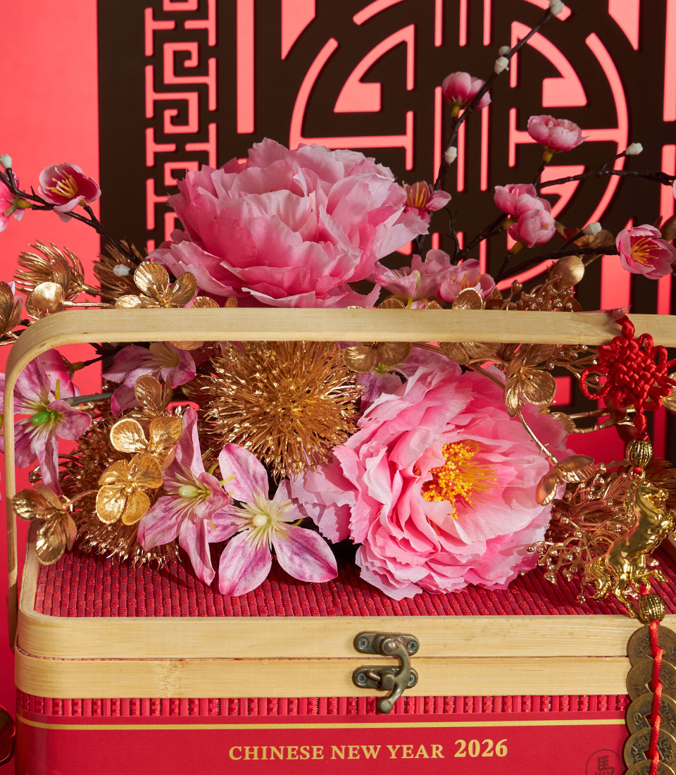Luxury red mandarin orange gift box with pink peonies and golden accents for Chinese New Year