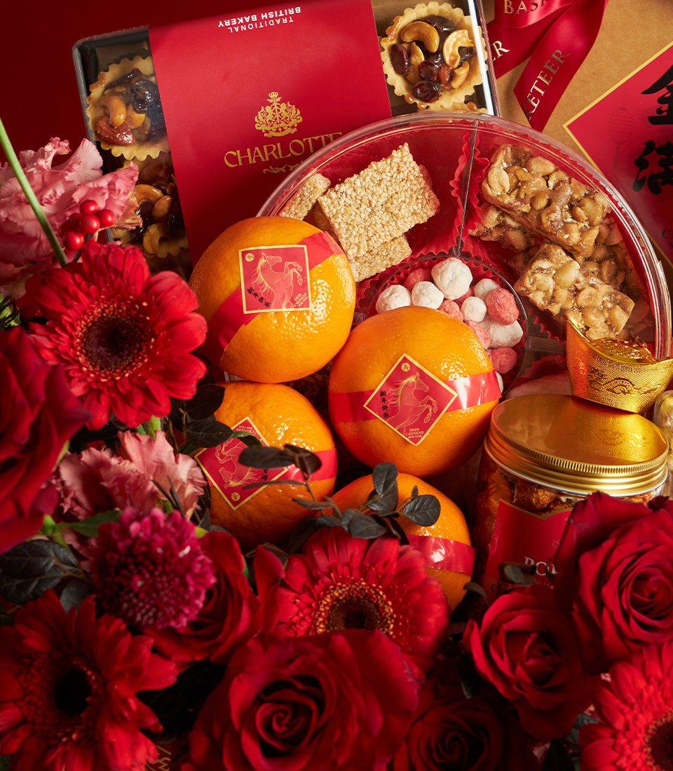 Luxury Chinese New Year gift basket with red and gold accents, British bakery treats, mandarin oranges, and fresh red roses