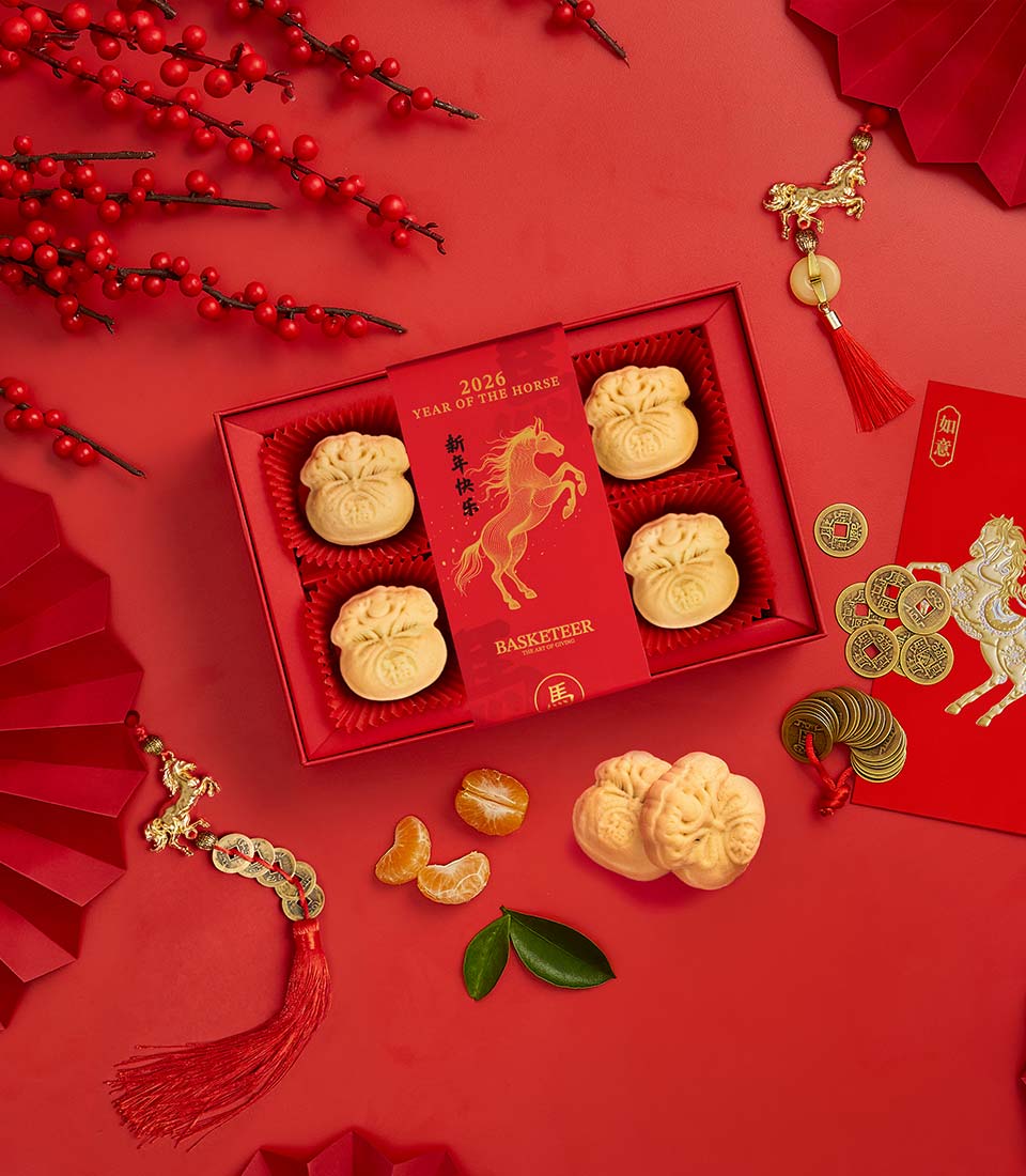 Red and gold Prosperity Pastry Box with embossed pastries, horse charm, and mandarin oranges for lunar new year celebrations