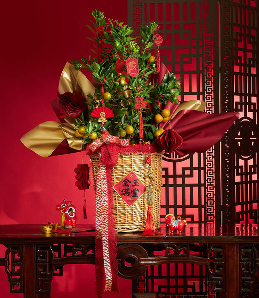 Festive kumquat tree Chinese New Year gift basket with red decorations, gold accents, and lucky symbols for 2026