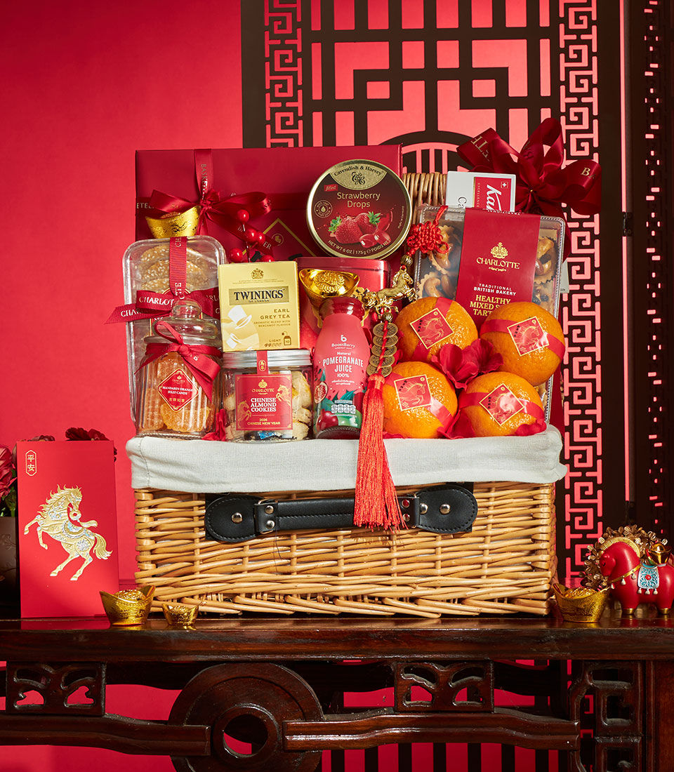 Festive woven gift hamper with premium mandarin oranges, gourmet tea and treats, red ribbons and gold accents for Chinese
