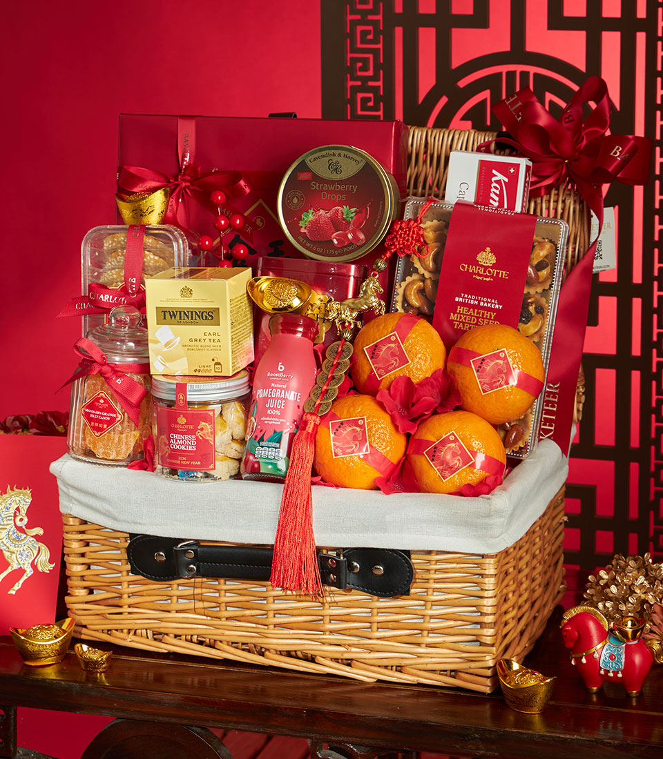 Premium wicker hamper with mandarin oranges, gourmet tea, and gold accents for Chinese New Year gifting