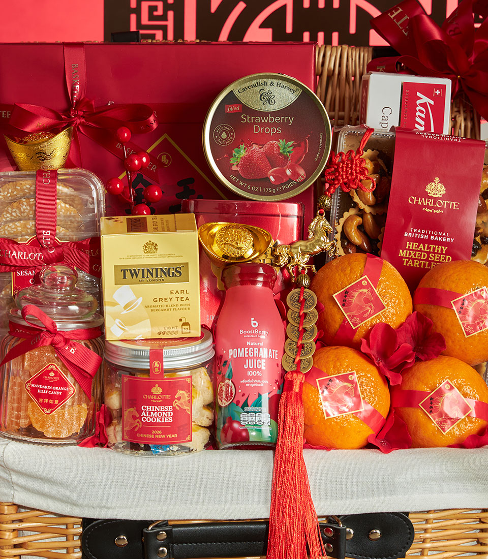Festive red and gold Chinese New Year luxury gift basket with mandarin oranges, premium teas, gourmet candies, and