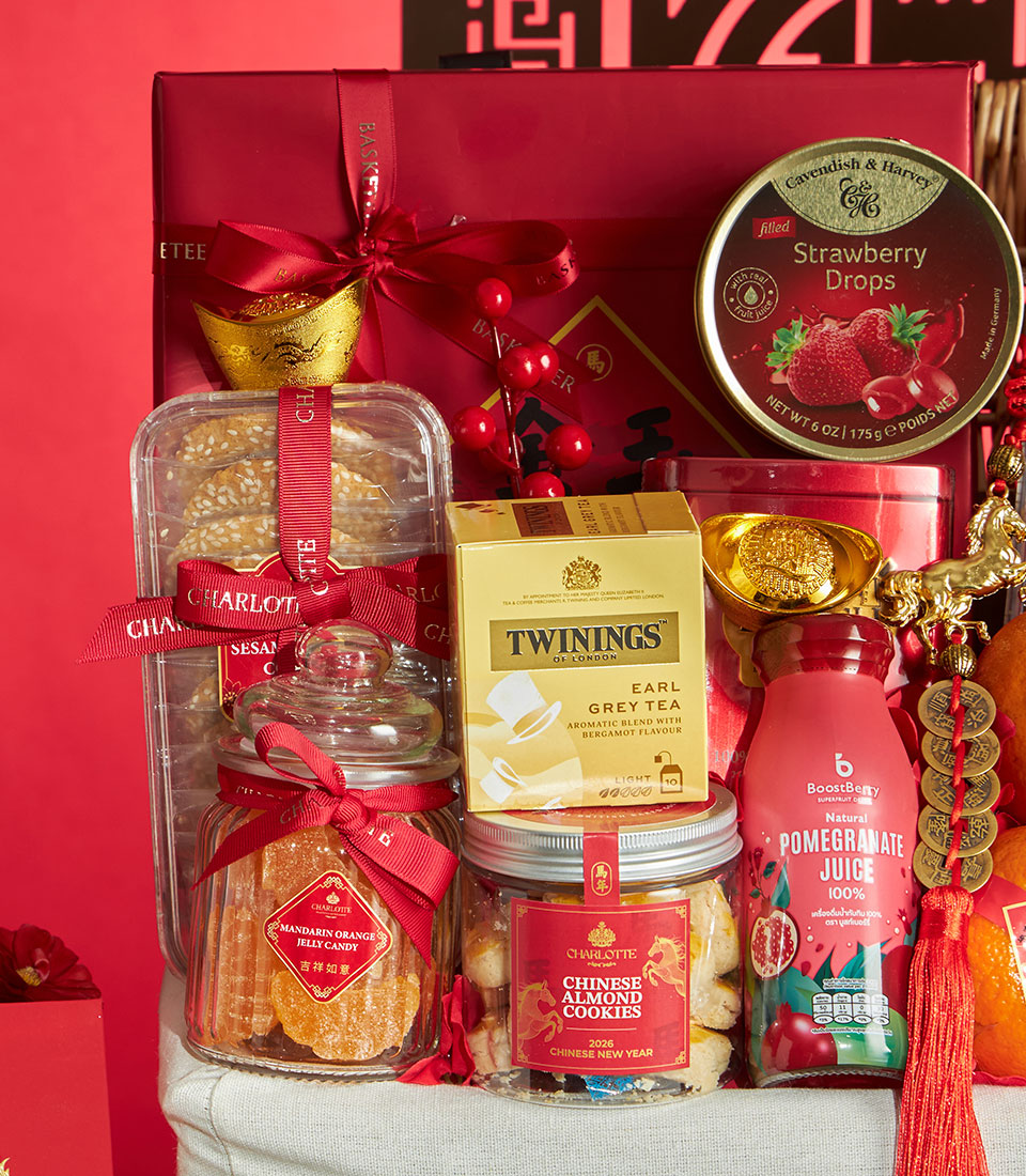 Festive red luxury gift basket with mandarin orange jelly, almond cookies, premium tea, and gold prosperity charms for