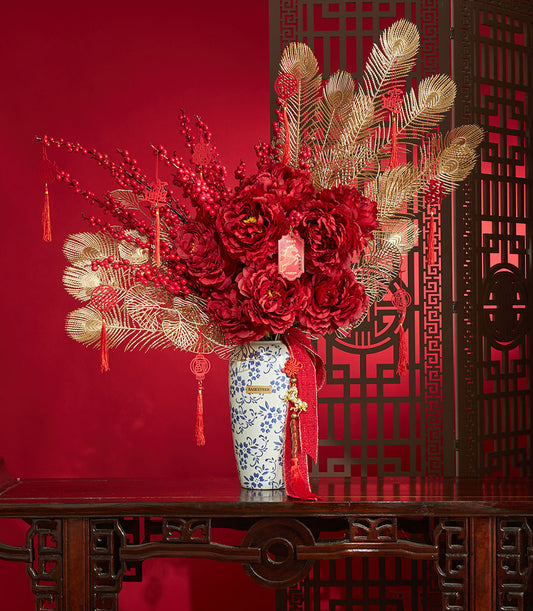 Deep red peony arrangement with gold peacock feathers and berries in blue-white ceramic vase, Chinese New Year gift