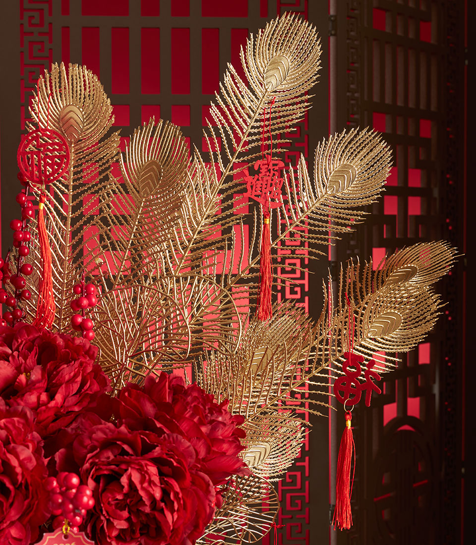 Red peony and golden peacock feather arrangement with fortune ornaments for Chinese New Year