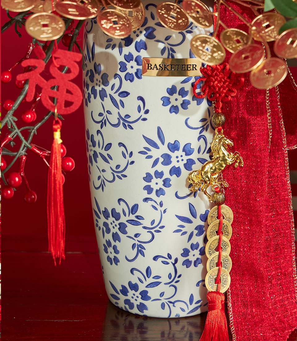 Basketeer premium hamper for Chinese New Year, featuring gold coin accents, red ribbon and festive floral vase. A luxurious gift for delivery in Bangkok.