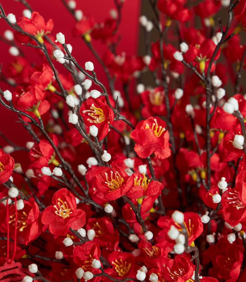 A Basketeer premium gift: close-up of a vibrant red cherry blossom arrangement with delicate white accents, perfect for Chinese New Year in Bangkok.