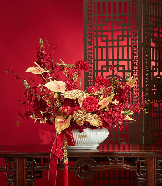 Basketeer premium hamper delivery Thailand: Red and gold artificial flowers in decorative vase, with festive red ribbon. Perfect corporate gift Bangkok.