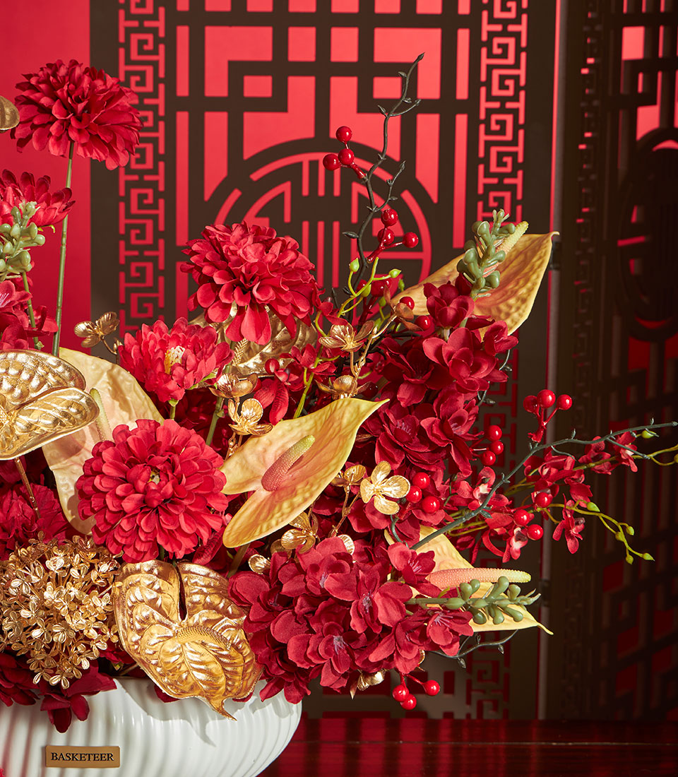 Basketeer premium hamper delivery Thailand: Red & gold artificial flower arrangement in a decorative vase, perfect for a luxurious corporate gift in Bangkok.