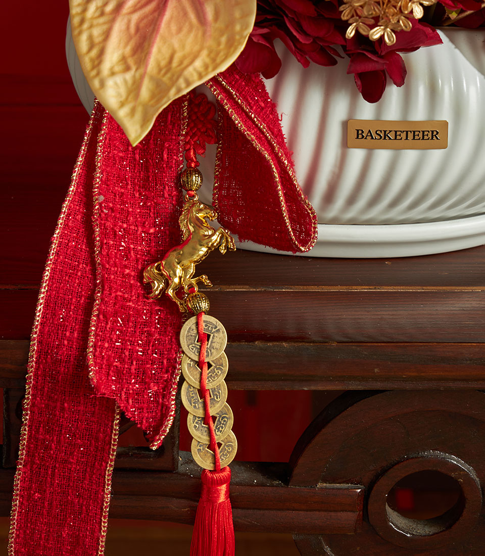Basketeer luxury gift: Red and gold floral arrangement in decorative vase, accented with a horse charm and lucky coins. Perfect for Chinese New Year.