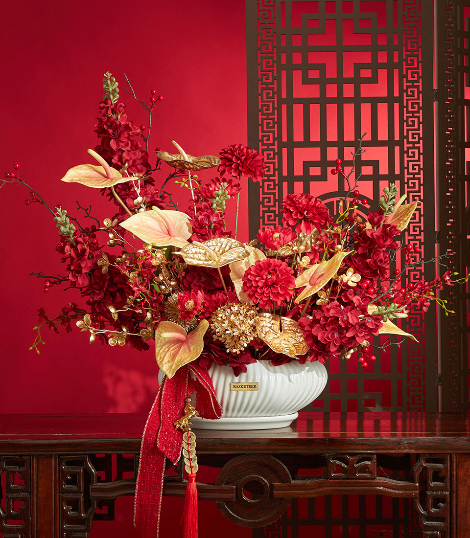 Basketeer premium gift: striking red and gold artificial flower arrangement in a decorative vase, perfect for Chinese New Year in Bangkok.