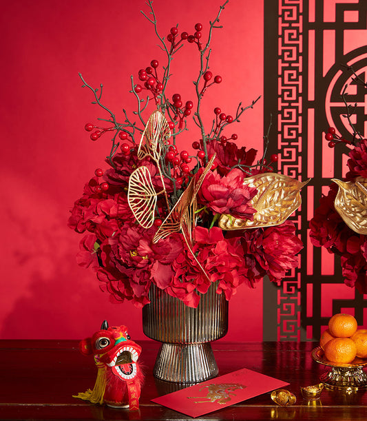 Basketeer luxury gift for Chinese New Year. Red floral arrangement with gold accents, plus mandarin oranges and a decorative dragon. Premium hamper delivery Thailand.