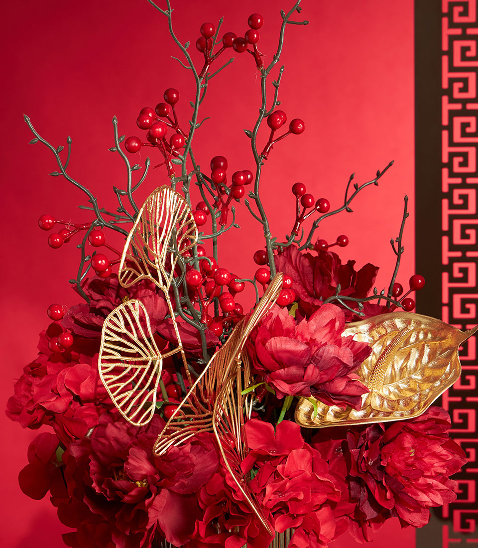 Basketeer's luxury gift for Chinese New Year: Lush red flowers accented with gold leaves and berry sprigs create a premium floral arrangement.