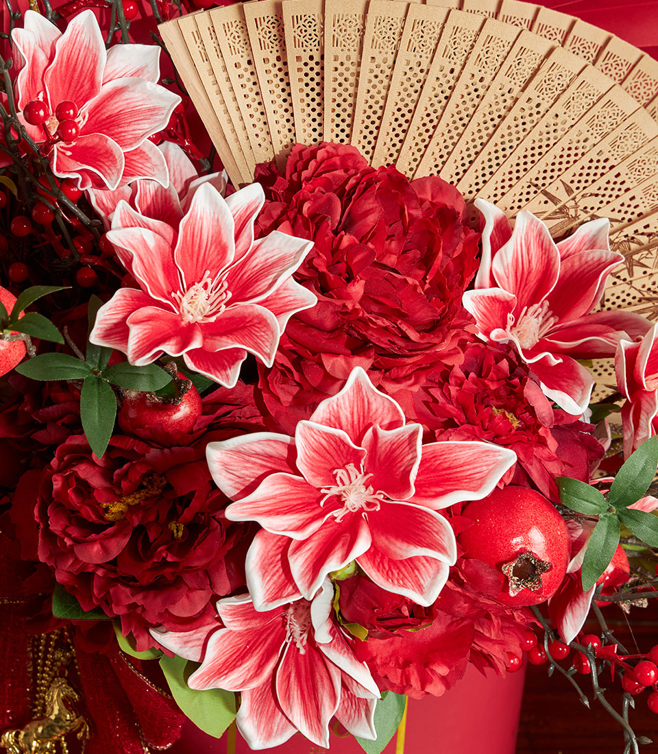 Basketeer's luxury gift for Chinese New Year: Red floral arrangement with peonies, decorative pomegranates and a traditional bamboo fan. Premium hamper delivery in Thailand.