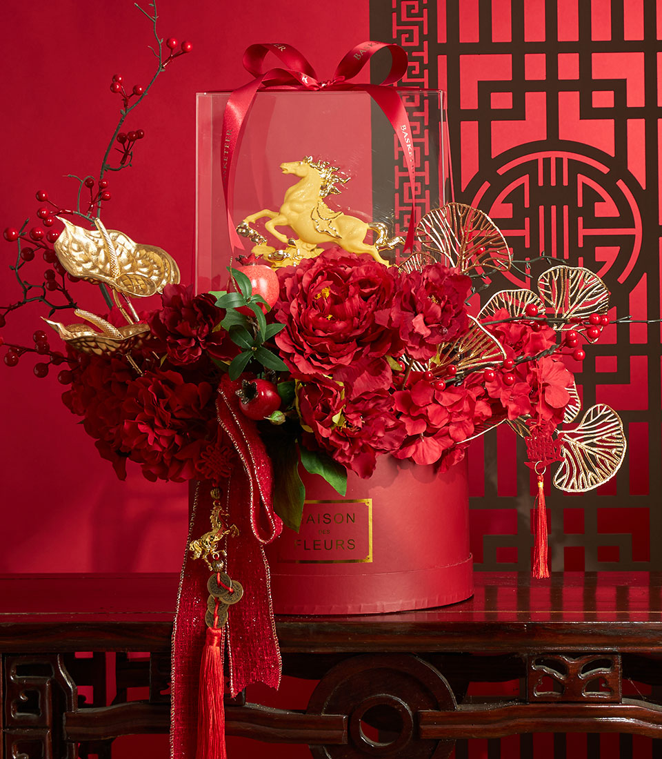 Luxury red peony and hydrangea arrangement with golden horse figurine and festive accents for Chinese New Year