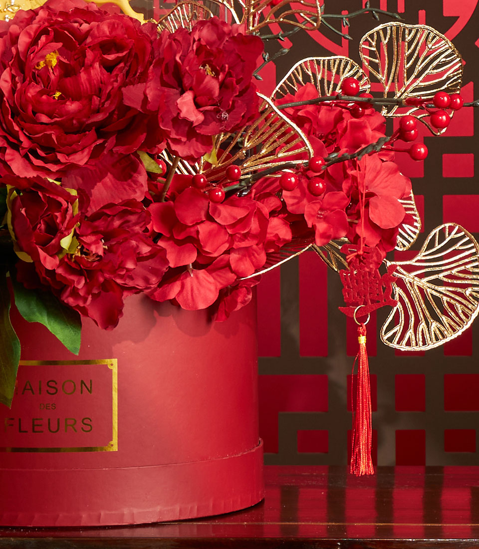 Vibrant red peony and berry floral arrangement with gold accents and Chinese tassel, Chinese New Year luxury gift