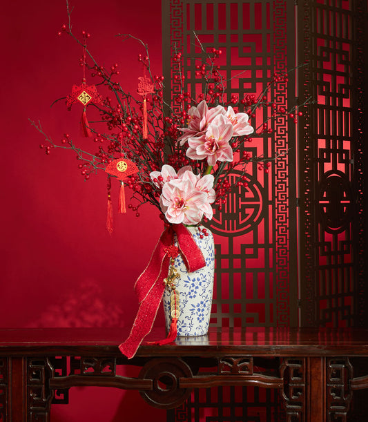Red and pink striped amaryllis with berry branches in blue ceramic vase, Chinese New Year luxury gift arrangement