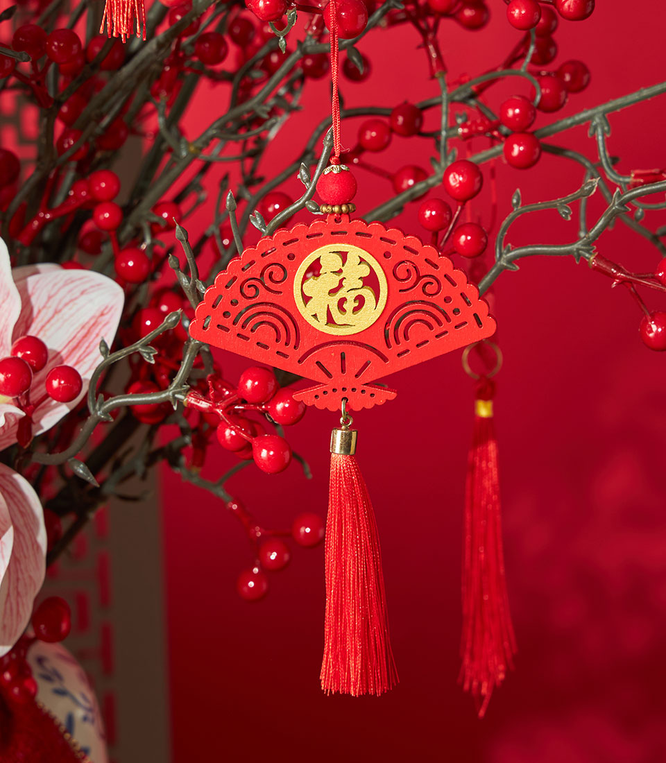 Red fan-shaped ornament with gold "福" character and red berries, Chinese New Year floral decoration with orchid arrangement