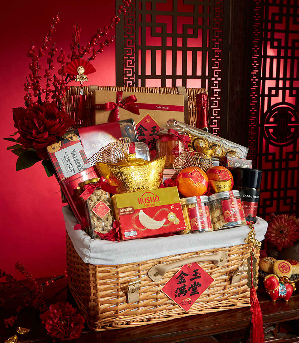 Luxury wicker Chinese New Year gift basket with red and gold accents, premium treats, and festive ornaments