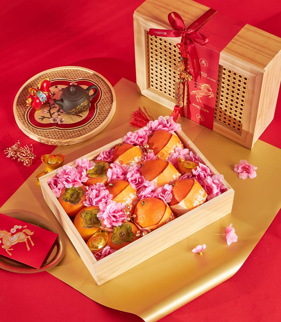Premium wooden fruit gift box with persimmons, tangerines, gold ingots and festive red ribbon for Chinese New Year