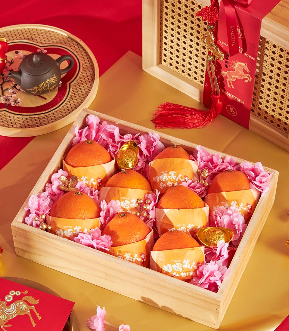 Premium mandarin orange gift box with gold accents and pink flowers, curated for Chinese New Year celebrations