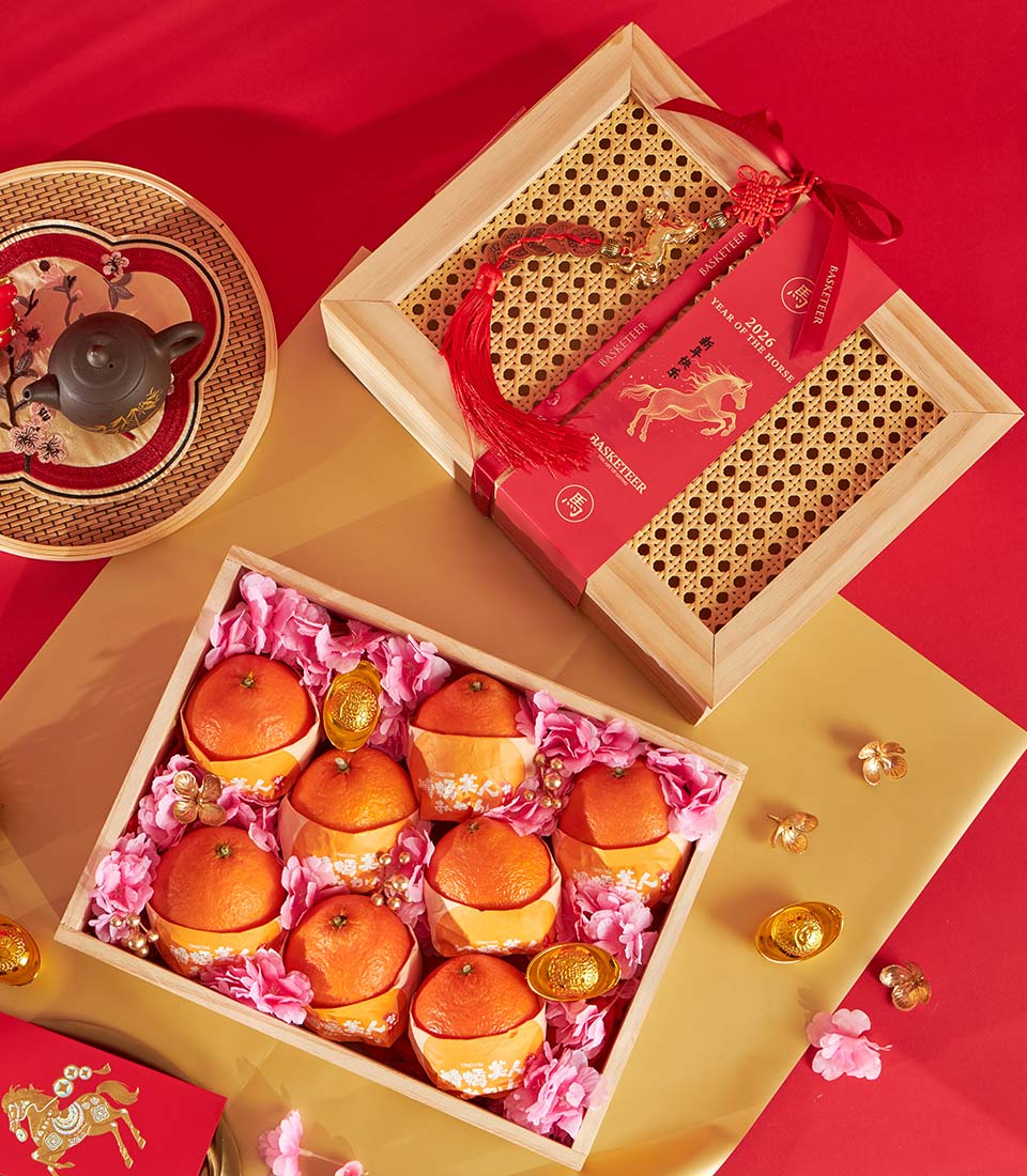 Premium mandarin orange gift box with rattan lid, red ribbon, and Year of the Horse charm for Chinese New Year celebrations
