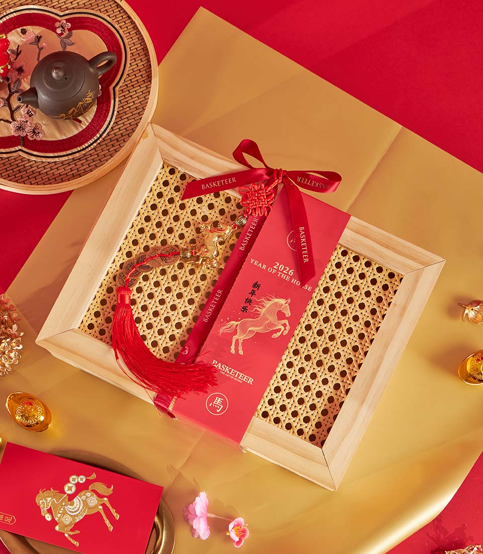 Luxury mandarin orange gift box with lucky red envelopes, golden horse charm, and premium tea for Chinese New Year