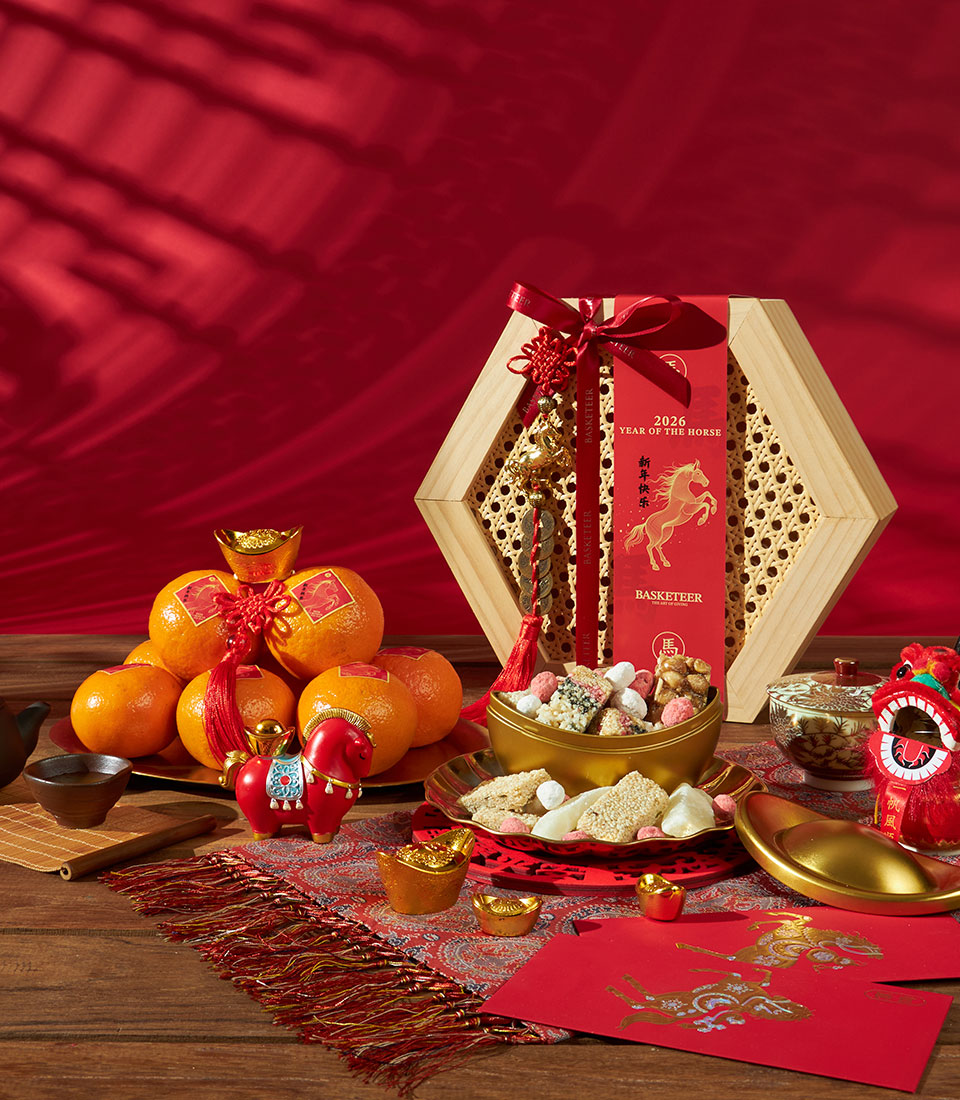 Premium mandarin orange and festive sweets gift set with hexagonal rattan box, red ribbon, and Year of the Horse charm for