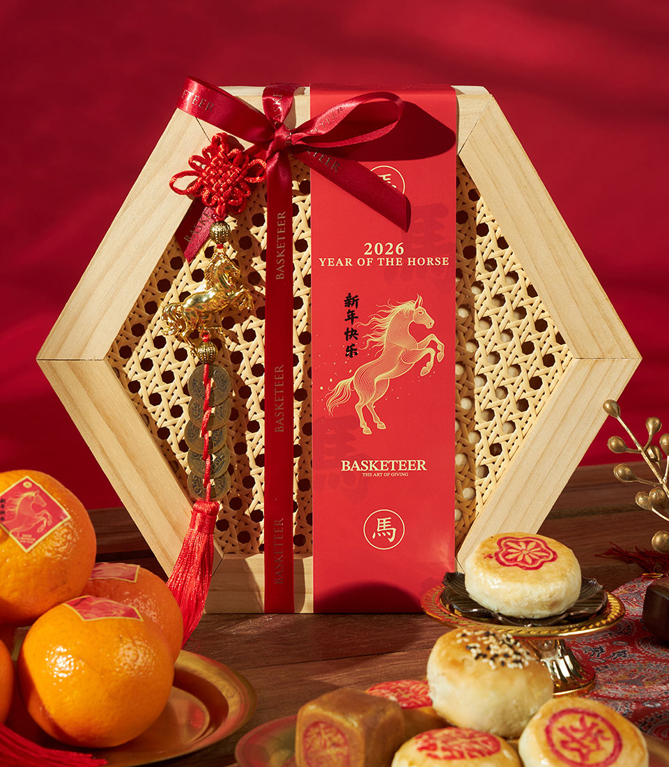 Premium Chinese New Year gift set with mandarin oranges, assorted pastries, and hexagonal wooden box adorned with gold horse