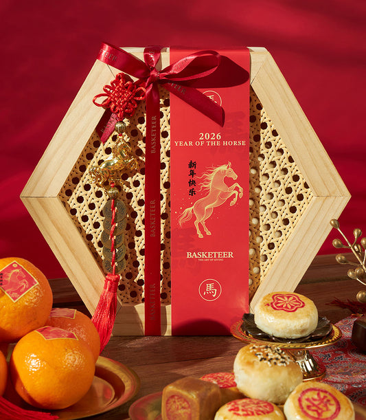 Premium Chinese New Year gift set with mandarin oranges, assorted pastries, and hexagonal wooden box adorned with gold horse