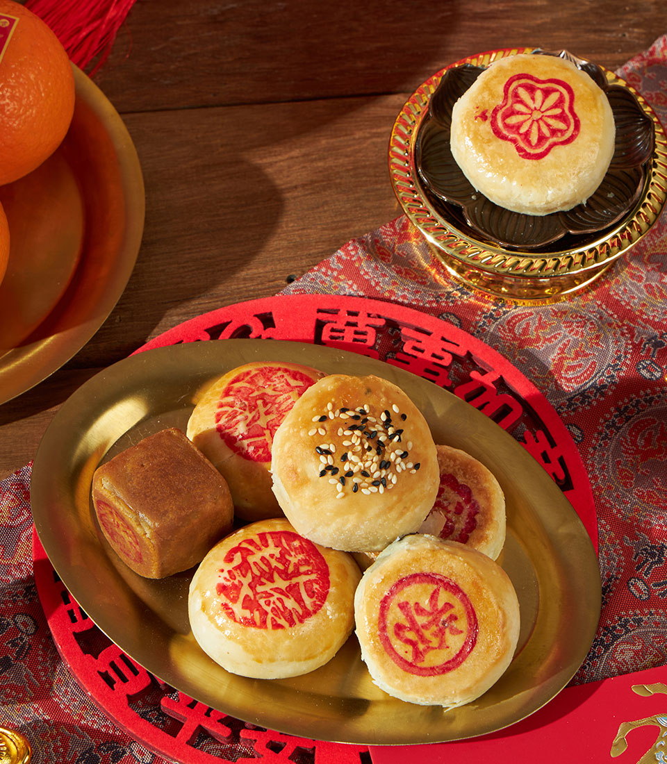 Premium mandarin oranges and assorted Chinese pastries gift set with red festive accents for lunar new year celebrations