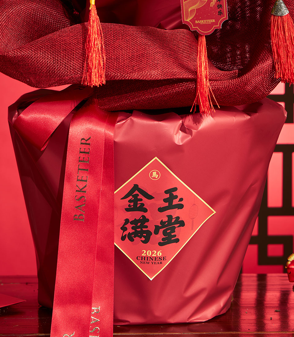 Festive red gift basket with kumquat tree for Chinese New Year, gold-trimmed label and tassel details