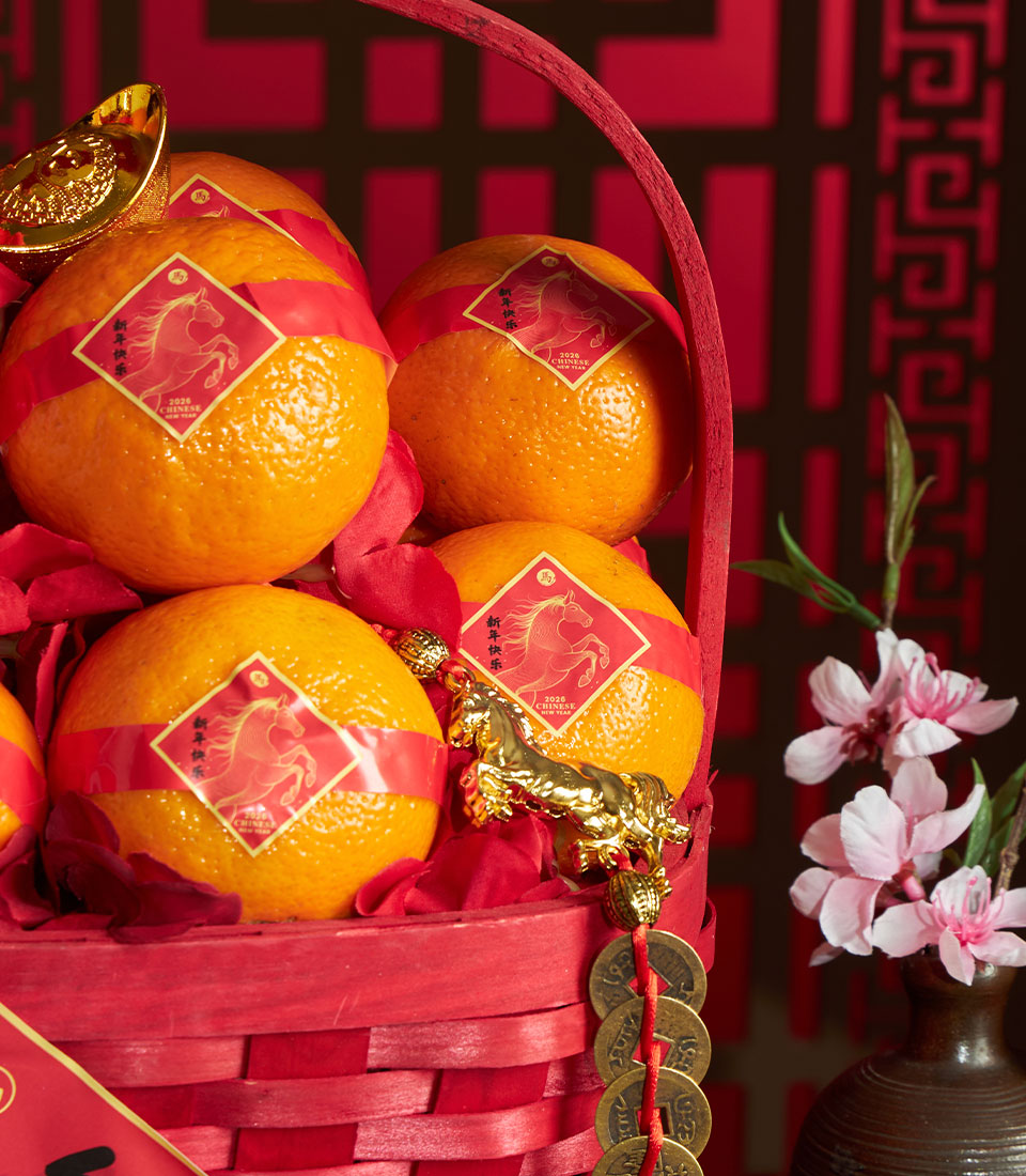 Red woven mandarin orange basket with lucky horse charm and silk flower accents for Chinese New Year