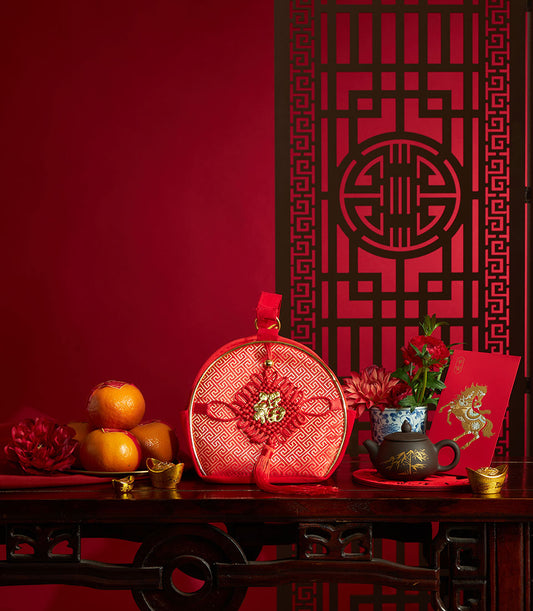 Chinese New Year mandarin orange gift set with red fabric pouch, gold fu character, oranges, and traditional festive accents