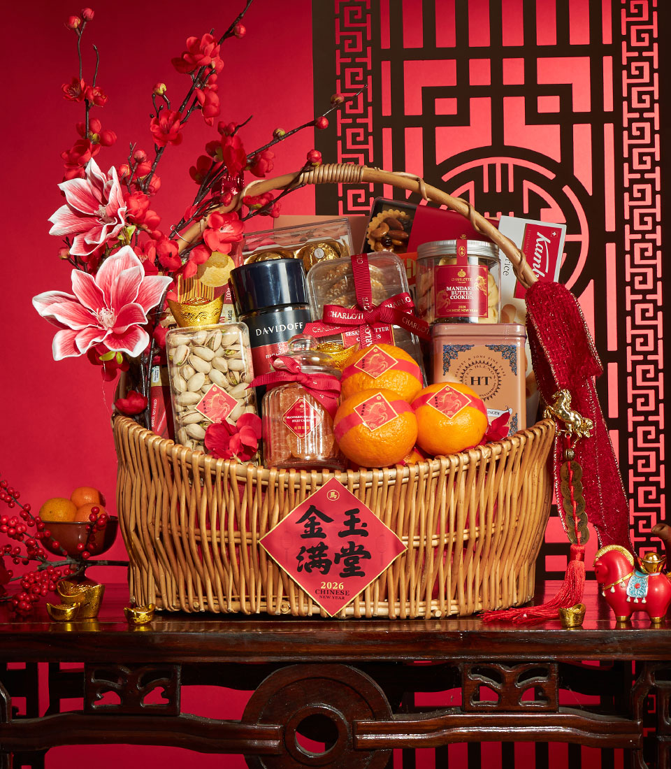 Luxury wicker gift basket with gourmet treats, fresh mandarin oranges, and festive red and gold Chinese New Year decorations