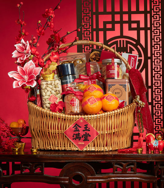 Luxury wicker gift basket with gourmet treats, fresh mandarin oranges, and festive red and gold Chinese New Year decorations