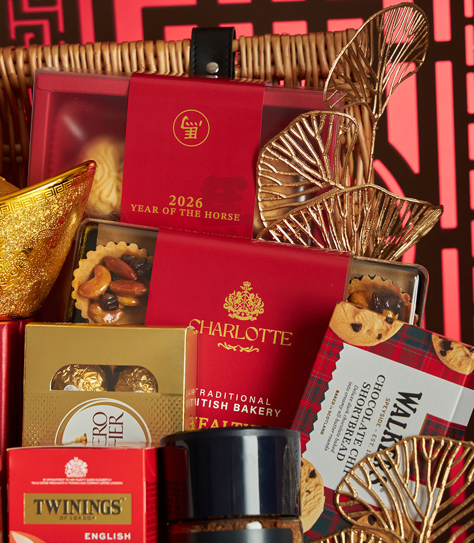 Festive Chinese New Year gift basket with red and gold packaging, gourmet chocolates, Twinings tea, Charlotte bakery treats,