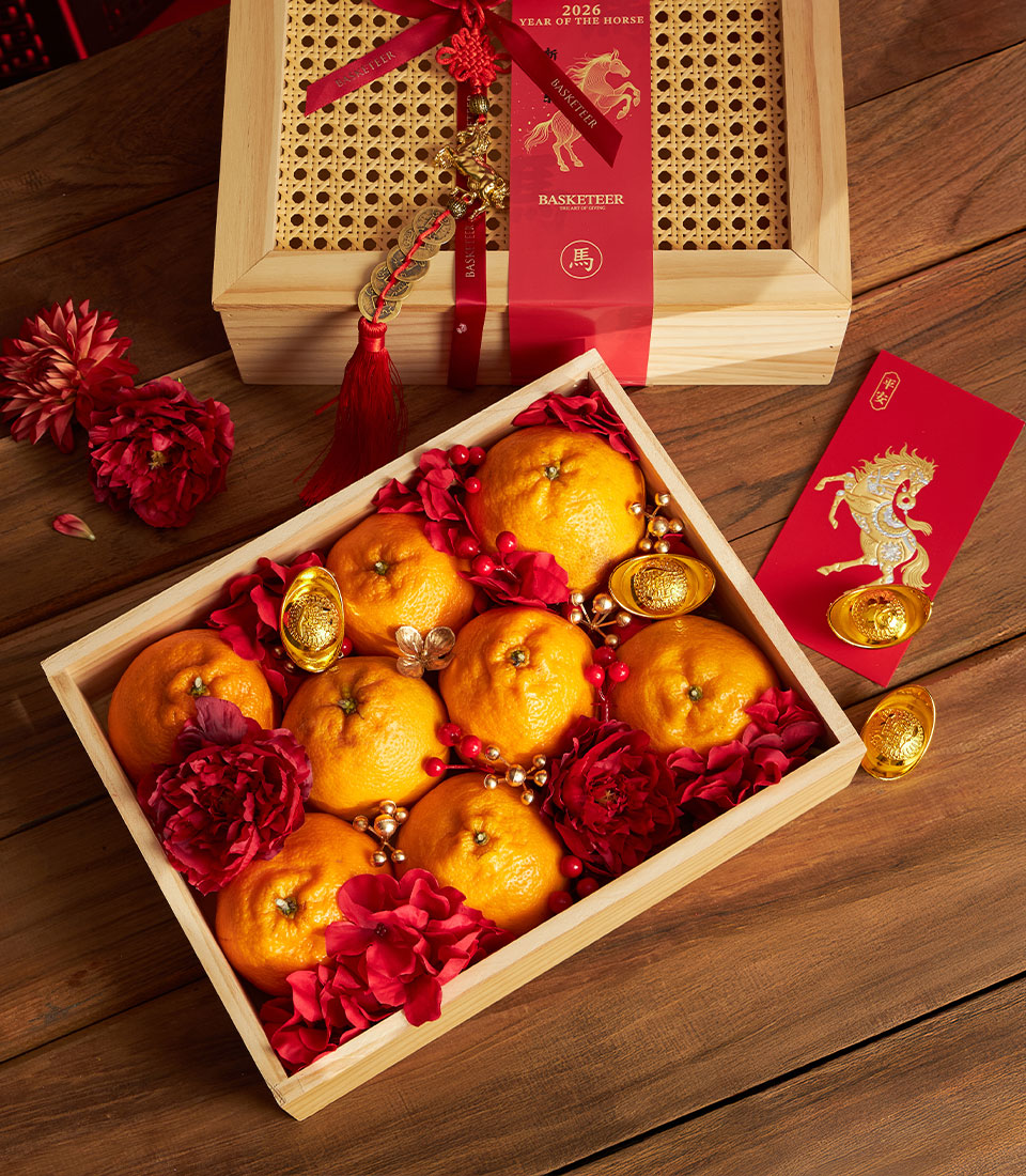 Dekopon orange prosperity gift box with rattan lid, red ribbon, and gold Year of the Horse charm for Chinese New Year