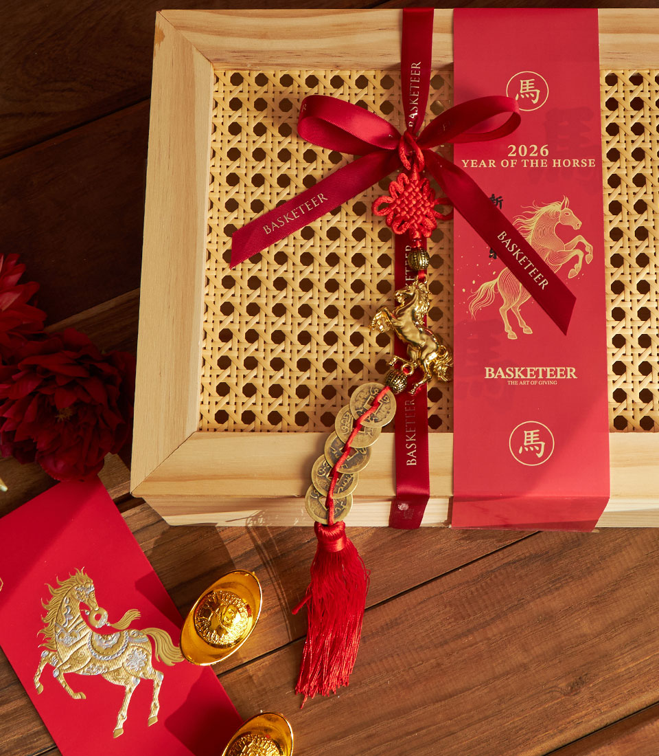 Luxury gift box with rattan lid, red satin ribbon, and Chinese New Year horse charms for prosperity gifting