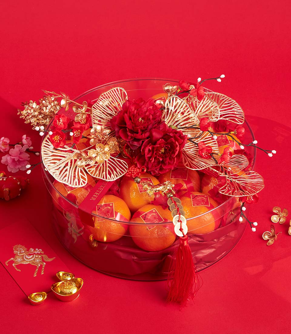 Luxury mandarin oranges gift bowl with red peonies, gold accents, and Lunar New Year decorations