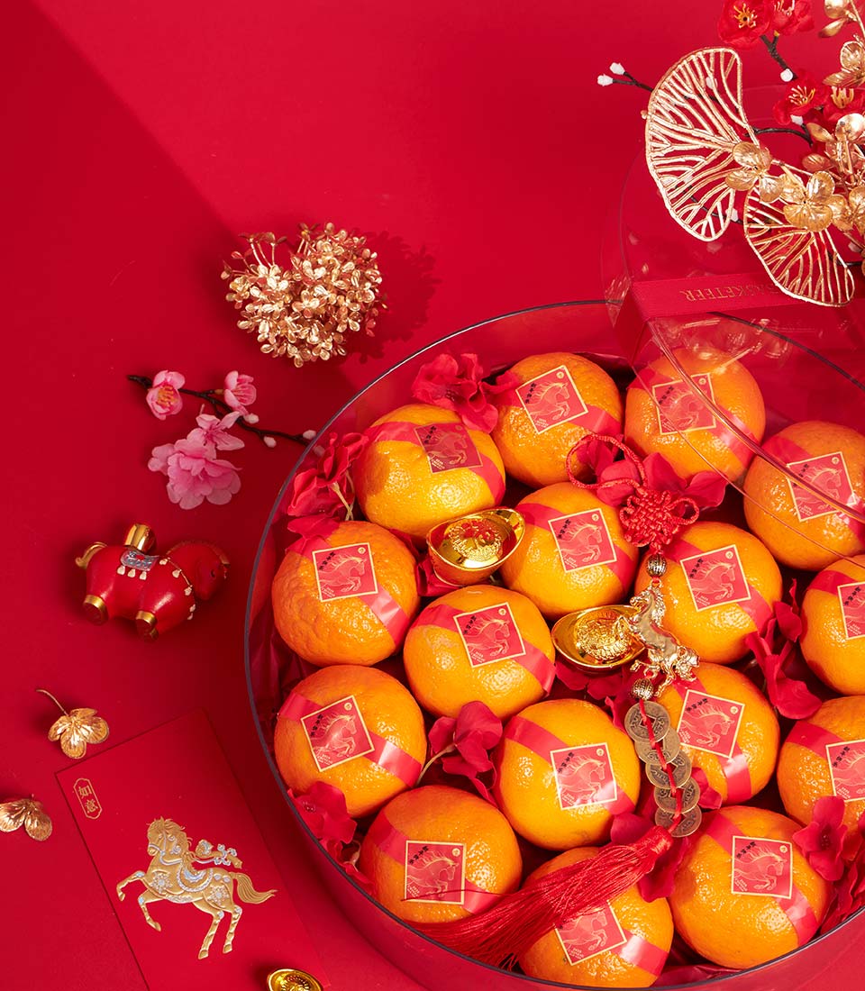 Premium mandarin oranges gift bowl with red ribbons, golden horse charm, and festive decorations for Chinese New Year