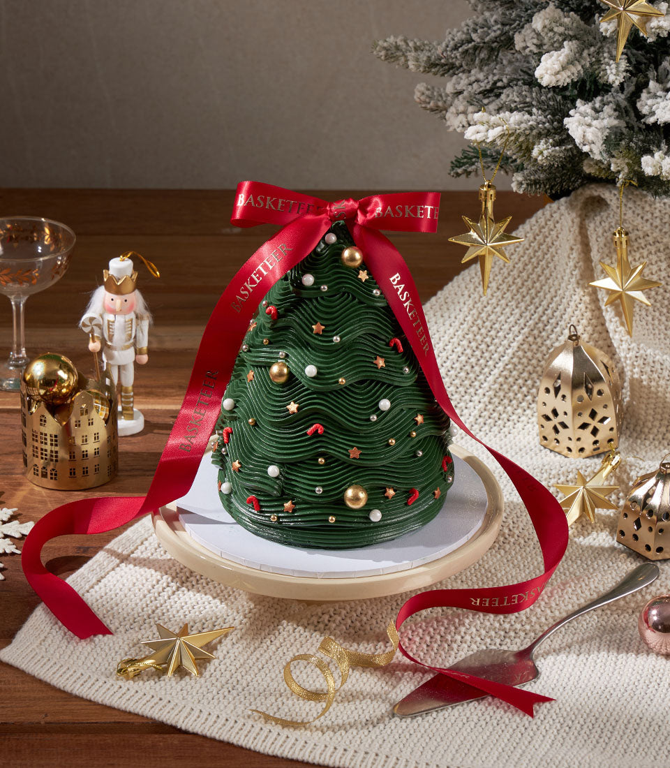 Charlotte Bakery Christmas tree cake: A festive, homemade artisan cake with smooth green buttercream, gold pearls, and star sprinkles. Perfect for birthday cake delivery in Bangkok!