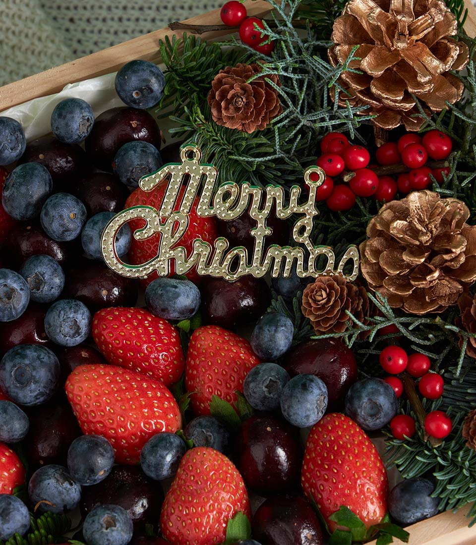 Festive Berry Fruit Gift Box with strawberries, blueberries, cherries, pinecones and Christmas ornament